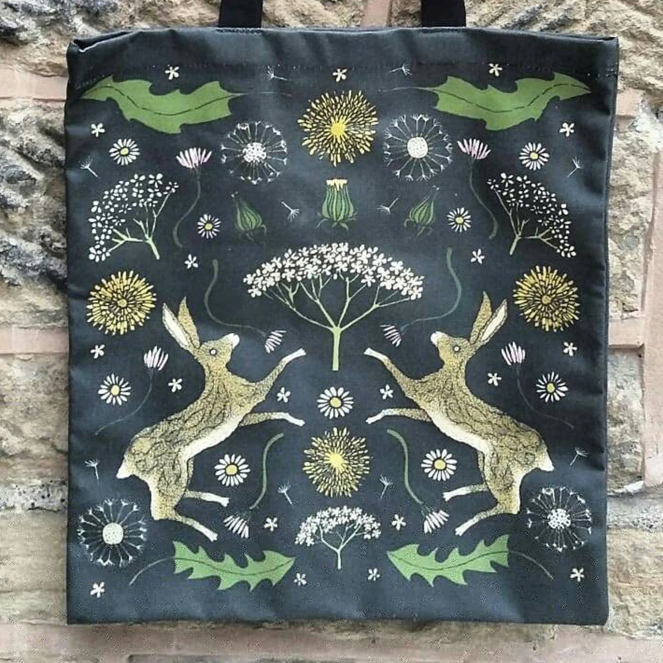 hares with black background, leaves and dandelions 