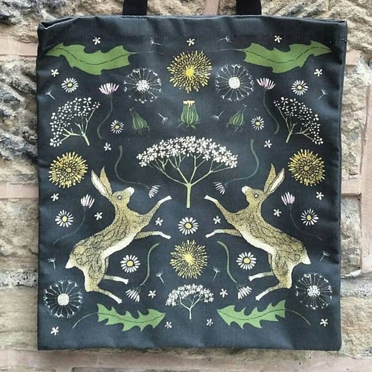 hares with black background, leaves and dandelions 